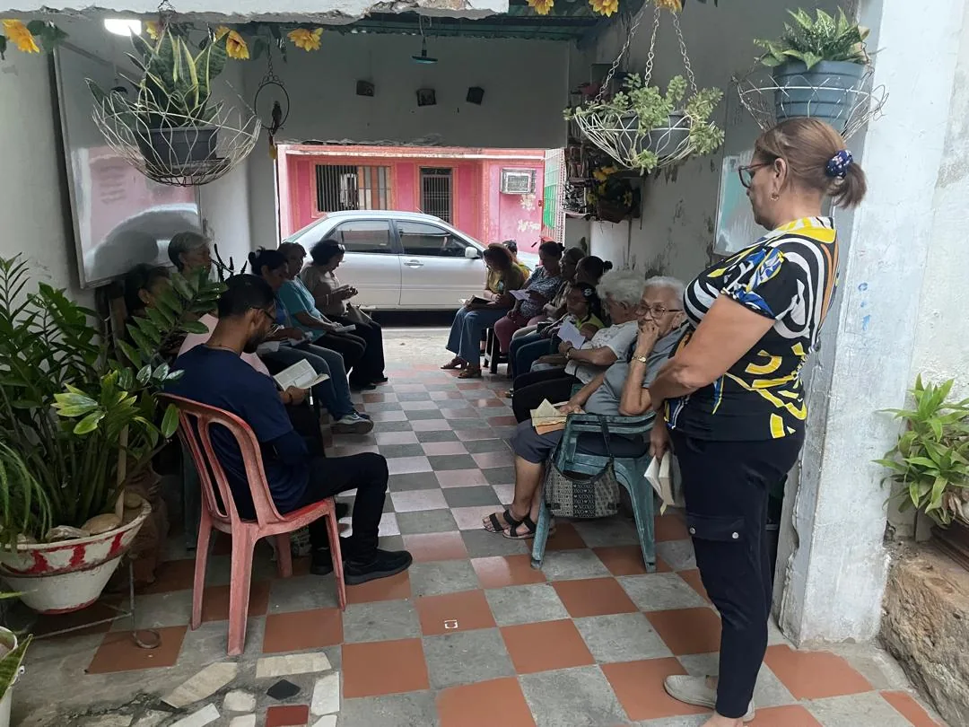 El grupo reunido en el patio de una casa, visto desde el fondo